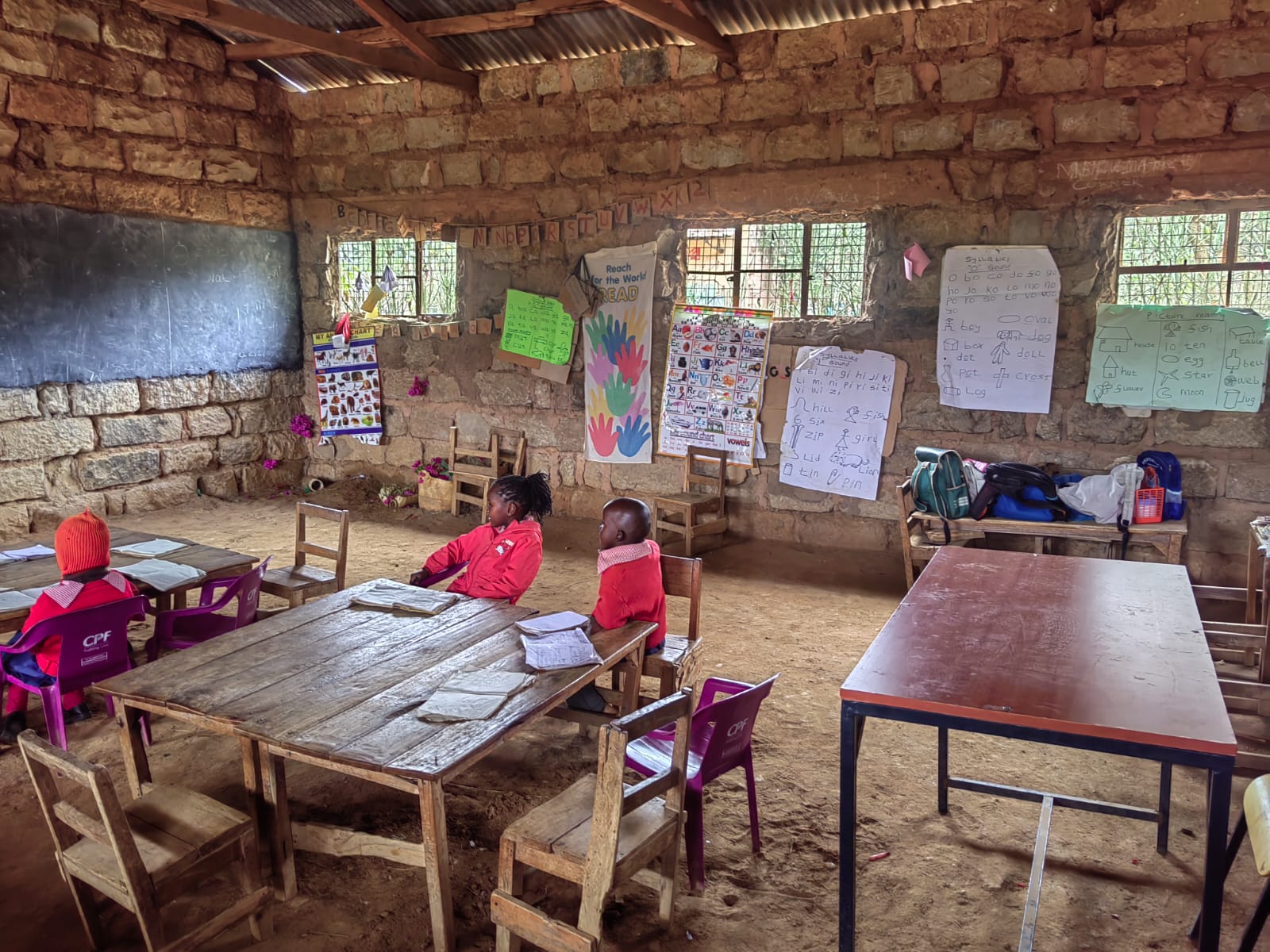 Learners and learning materials in a stone classroom