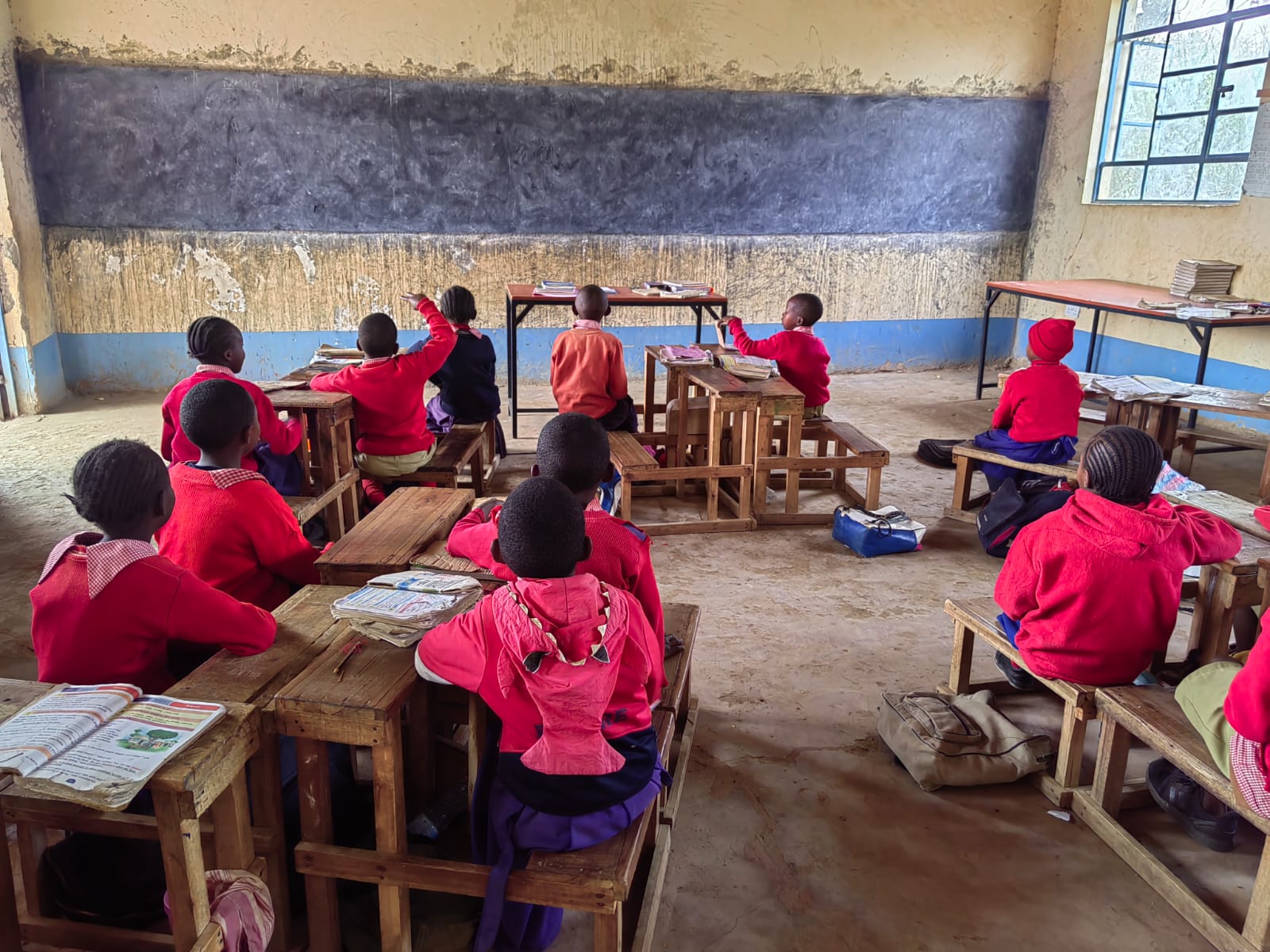 Learners seated at desks during a classroom lesson